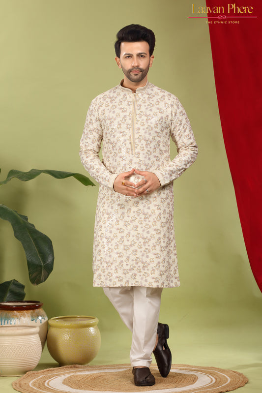 Man wearing a white kurta with a subtle pattern on a green background